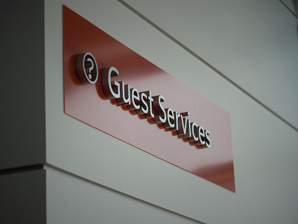 Sign on wall showing Guest Services area
