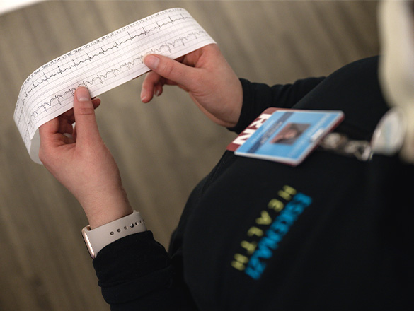 Registered nurse reviewing cardiology machine transcripts
