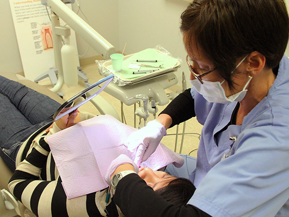 Dentist working on patient who is laying in a dental chair
