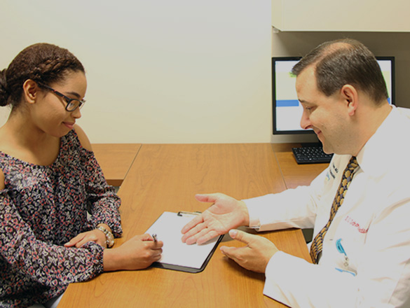 Doctor explaining a consent form to a research participant