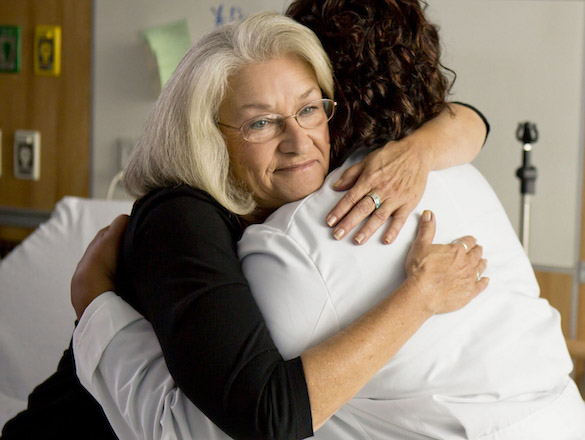 Two women hugging in a hospital room