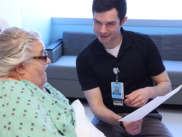 Male social worker talking with female inpatient