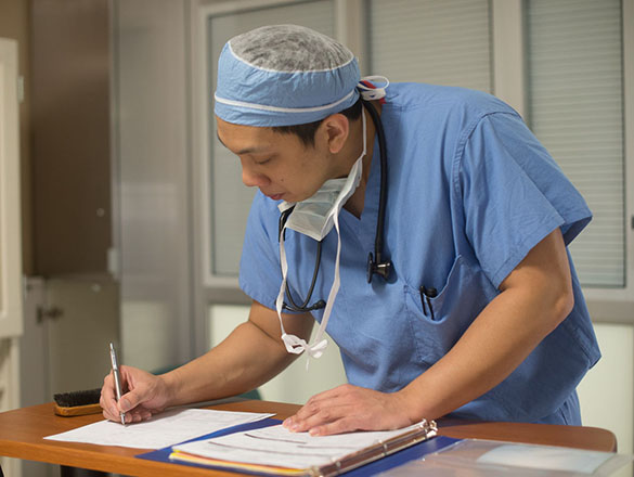 Provider taking notes in a chart