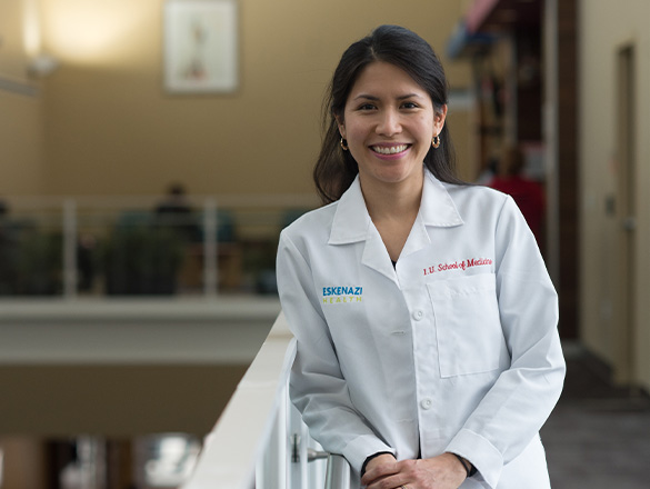 An Eskenazi Medical Group provider smiles while leaning on a railing